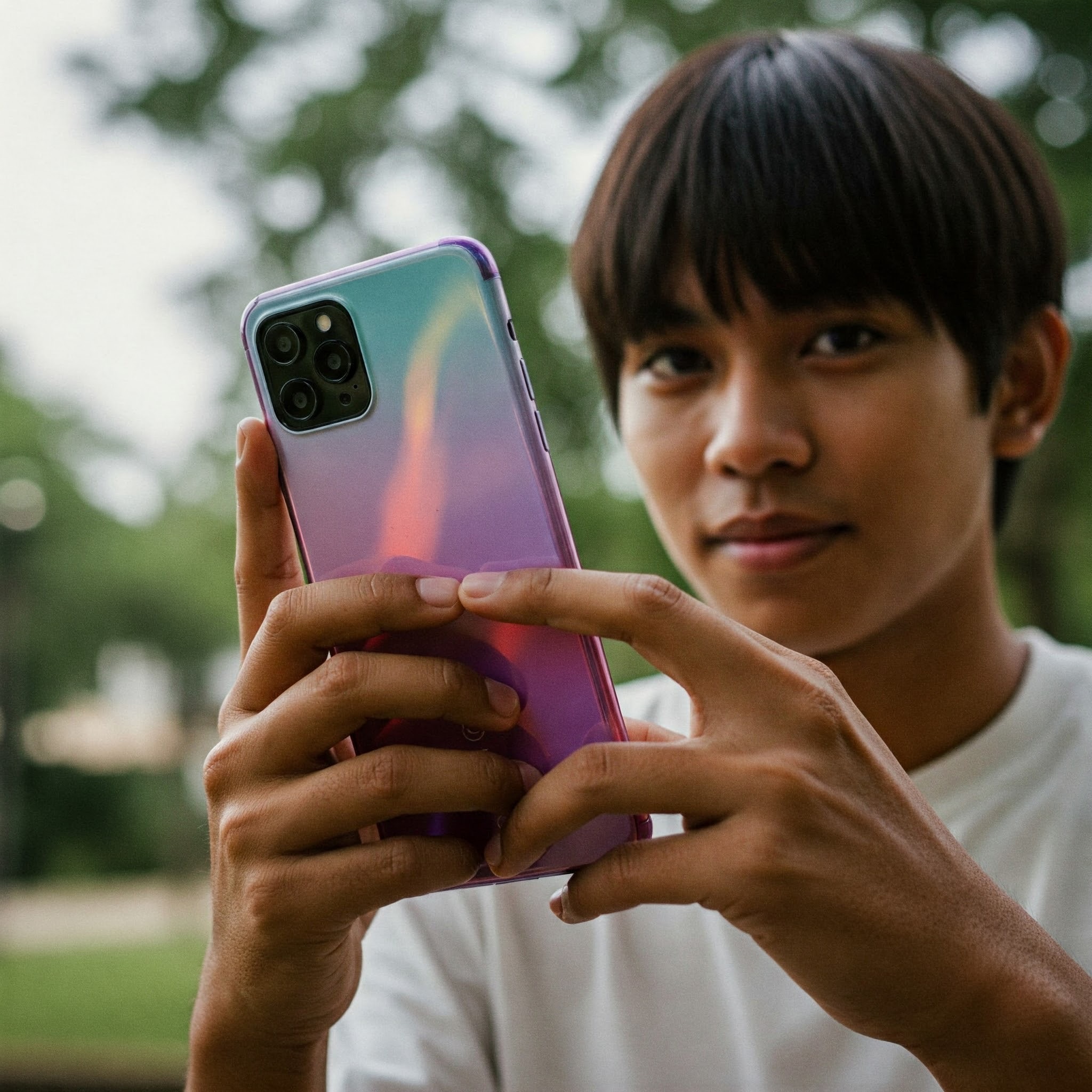 photo of Young Man Holding Colorful Smartphone